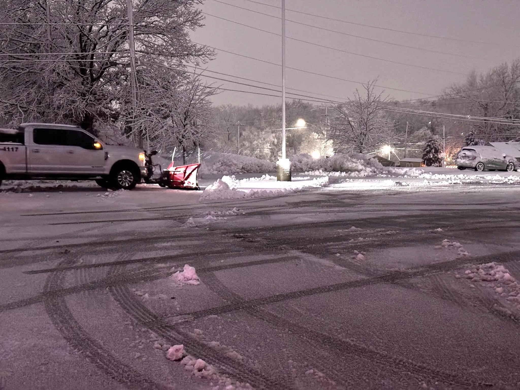 Professional snow removal equipment clearing a commercial parking lot in Kansas City