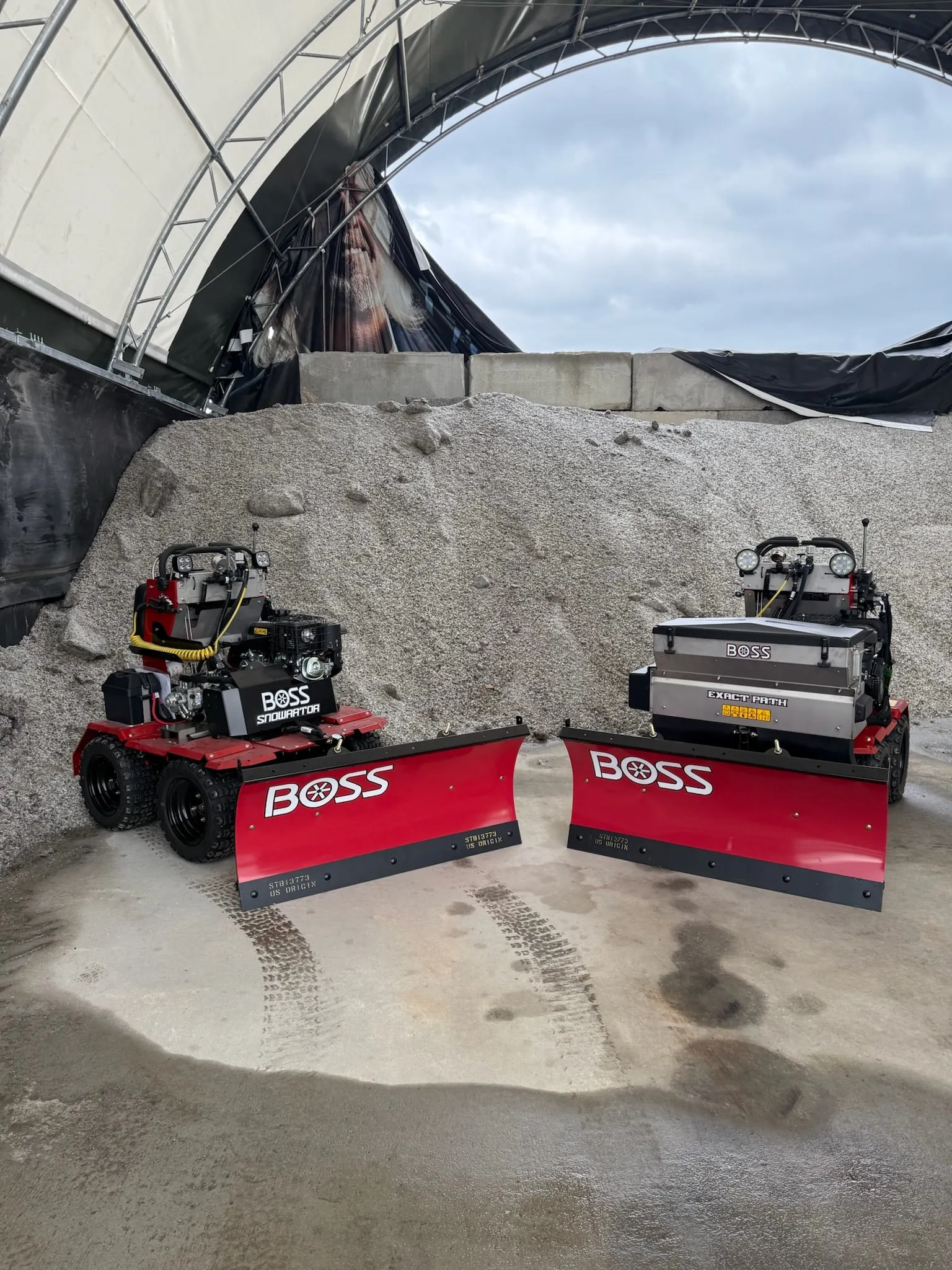 Pair of BOSS stand-on plow units with GPS-guided salt spreaders staged at our shop